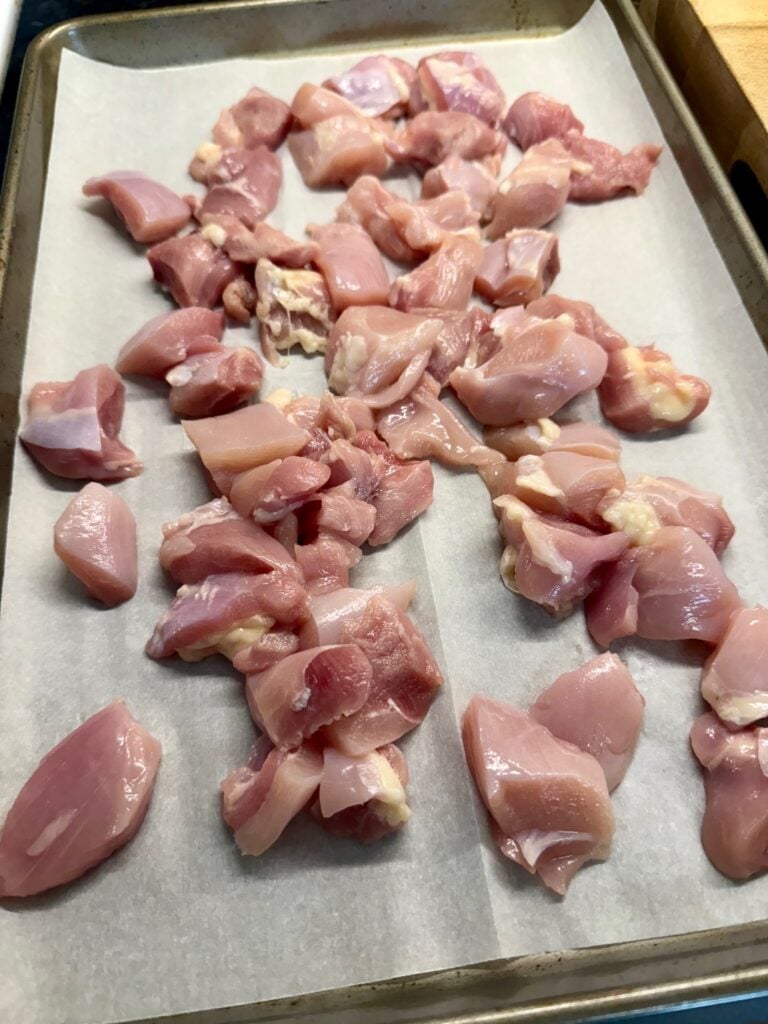chicken on a sheet pan before cooking