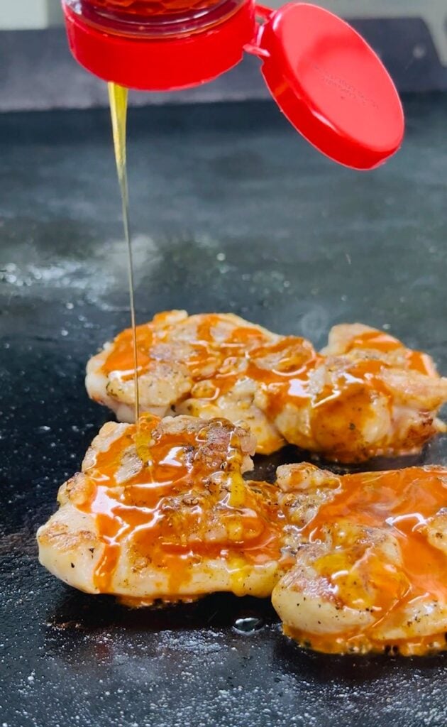adding hot honey to chicken