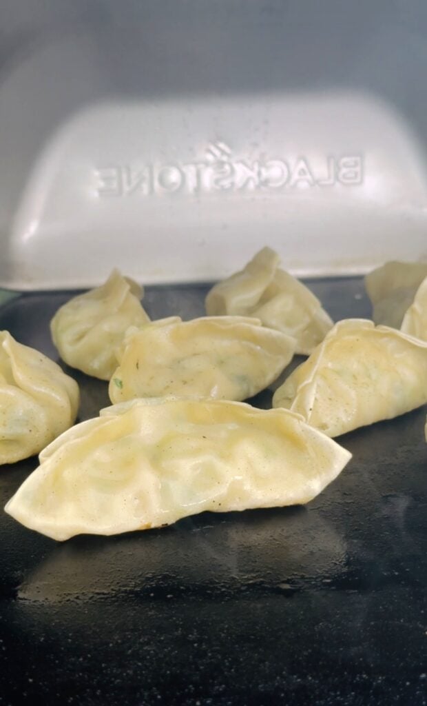 covering the potstickers on the griddle