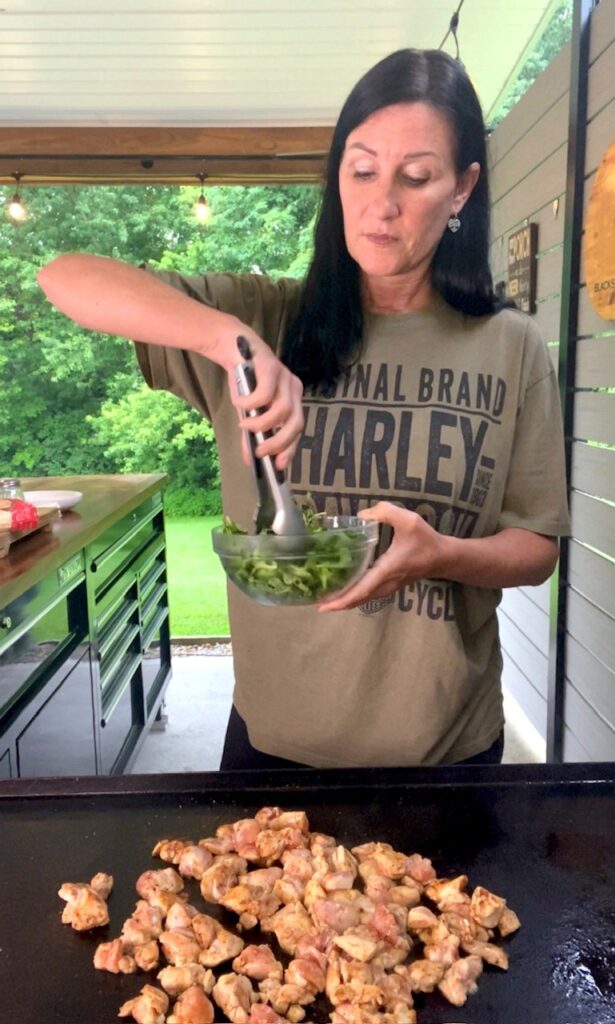 tossing the salad in a bowl