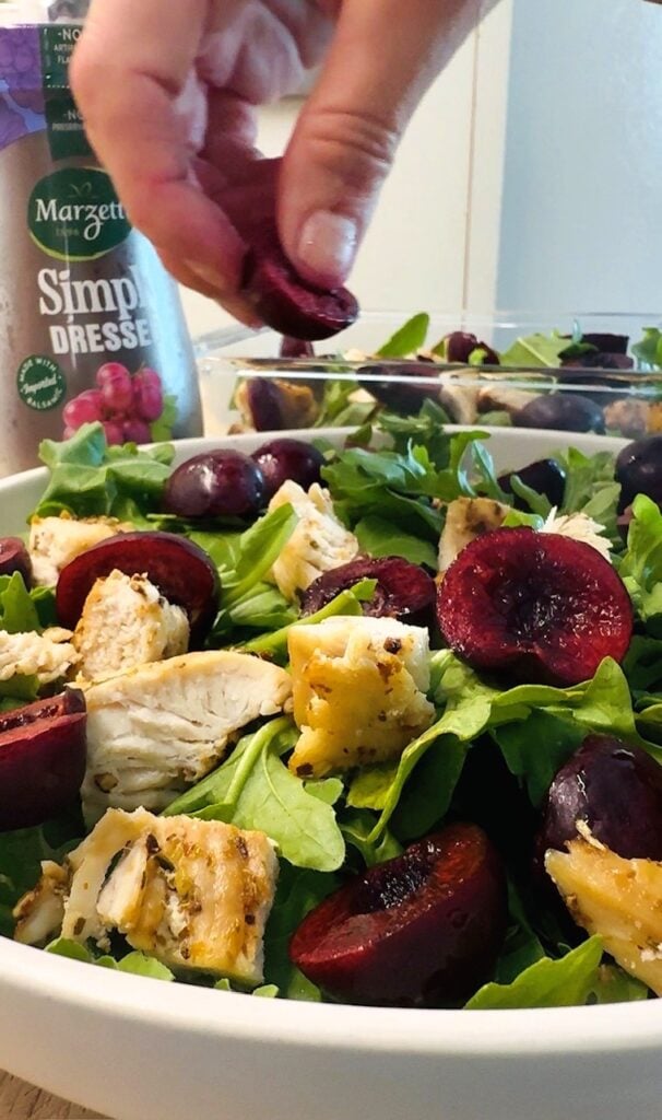 adding cherries to salad