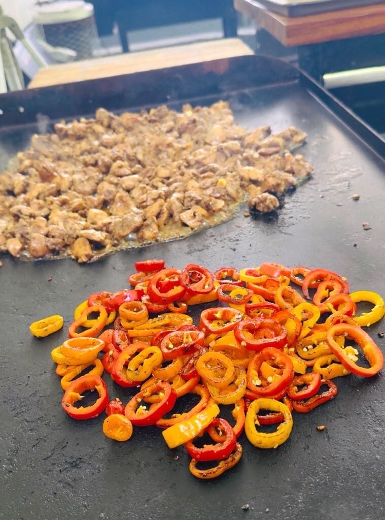 chicken and peppers on the griddle