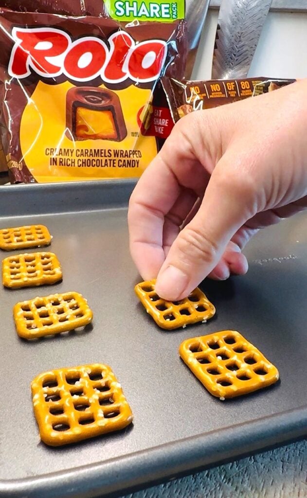 adding pretzel snaps to a baking sheet