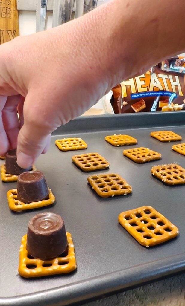 adding Rolo candy to pretzels