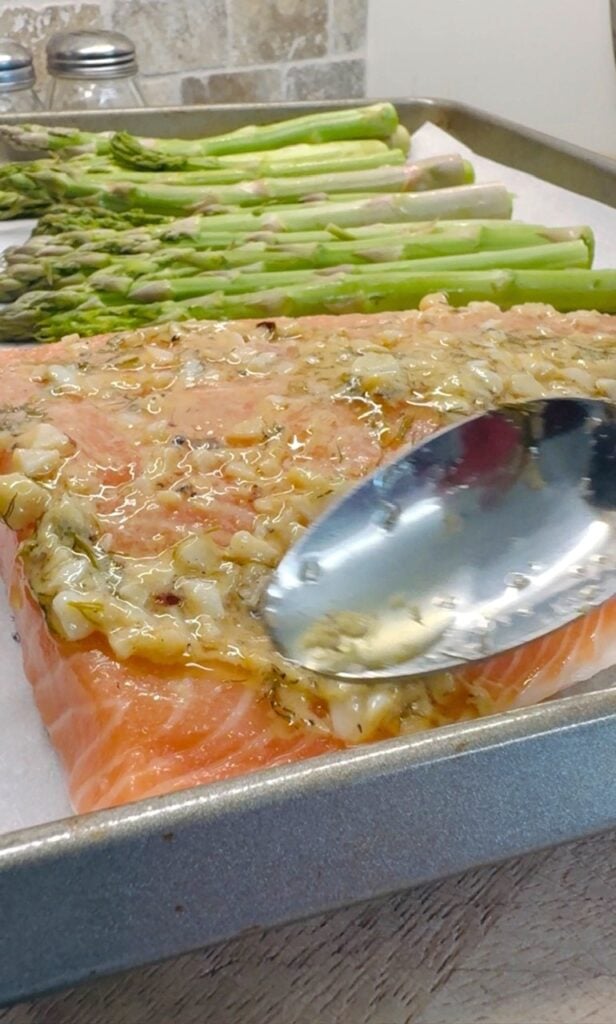 adding sauce to the salmon