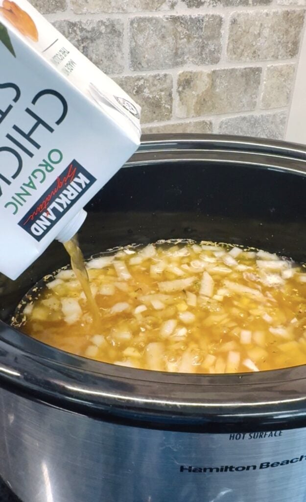 adding chicken broth